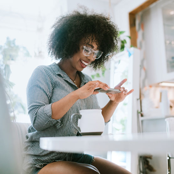 Young woman depositing check with phone