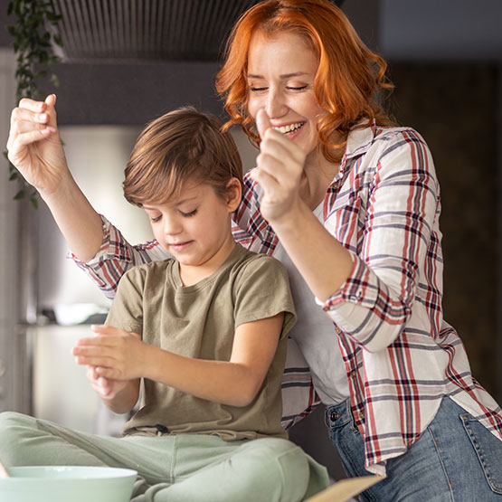 Mother and son cooking in kitchen