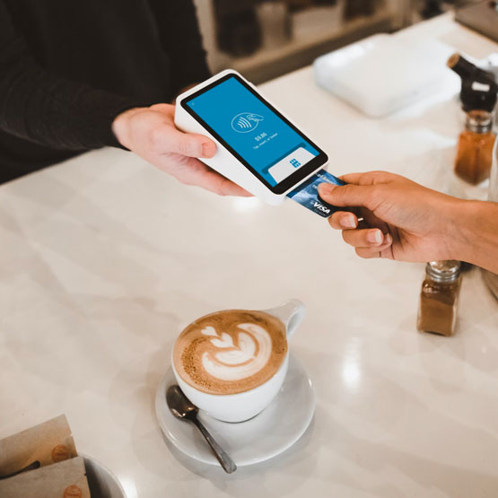 Person paying with credit card at business