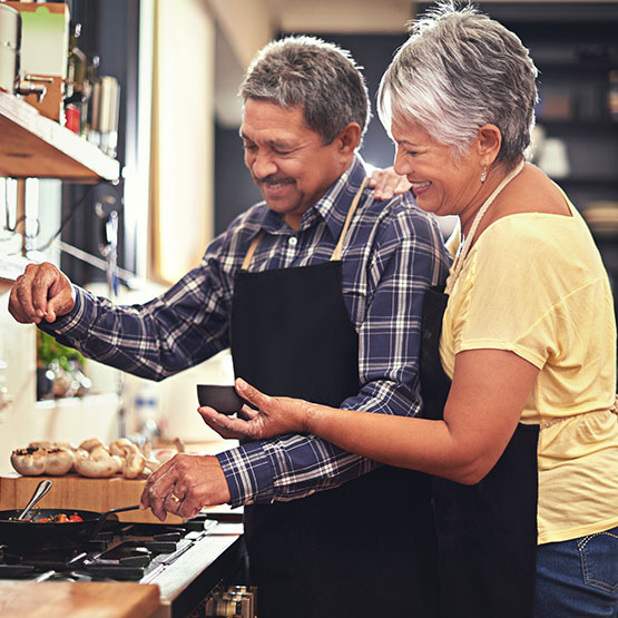 Senior couple cooking in kitchen